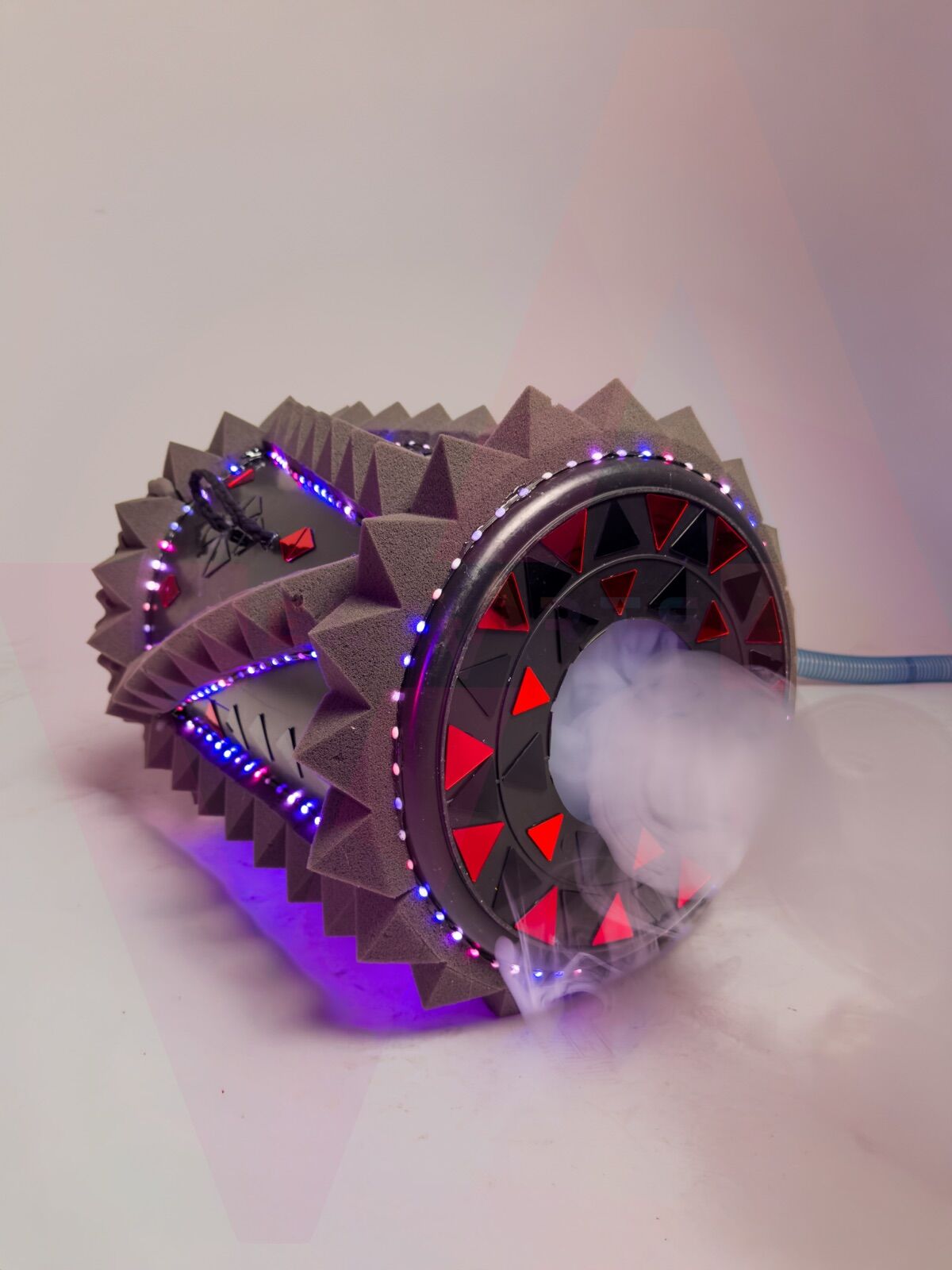 Vortex Fog Cannon firing a dense ring of fog, LED strips lit blue and red along the foam body